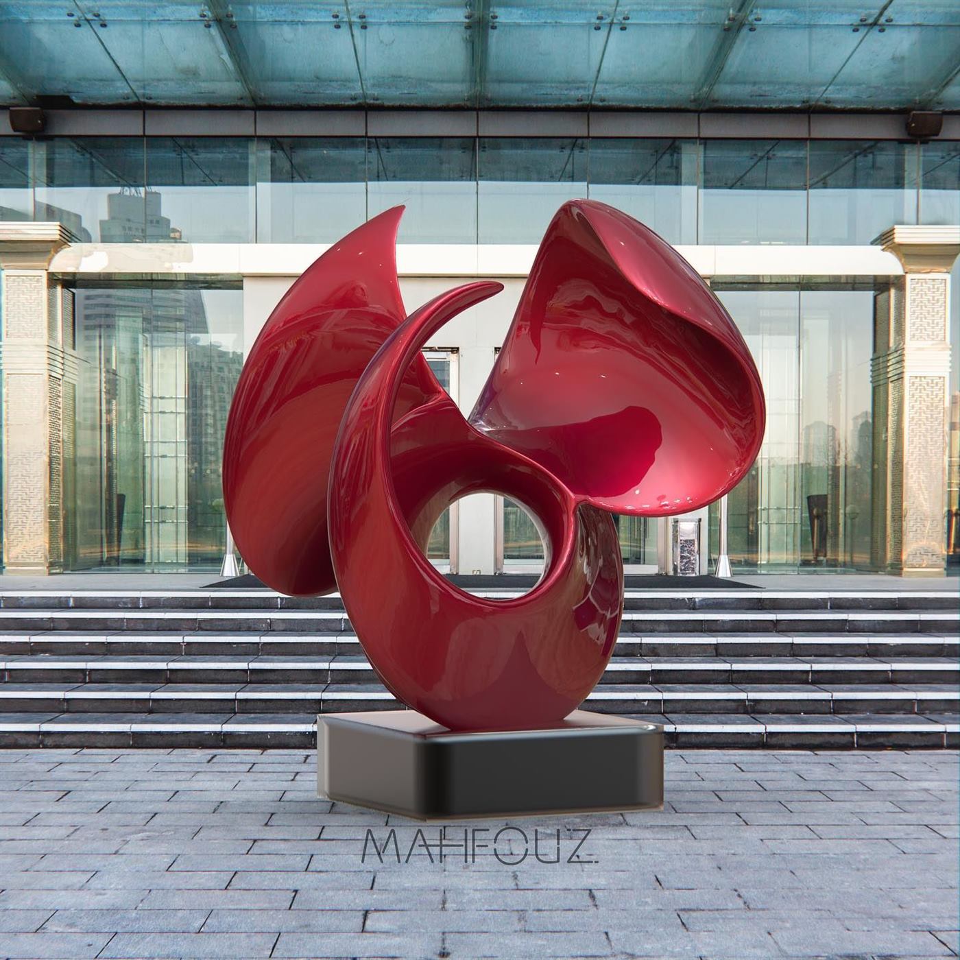 Glossy red abstract bloom sculpture at a glass building entrance