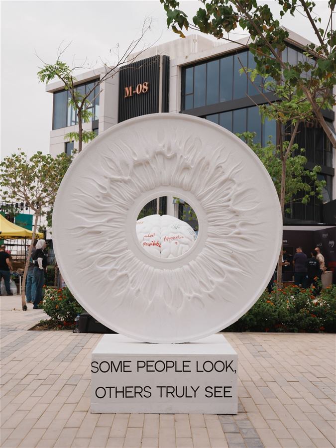 Carved white ring sculpture reading some people look, others truly see